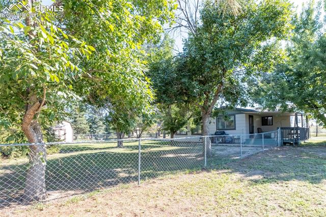 6010 Curtis Road Peyton, CO 80831 - Photo 6 of 42 Fenced area for Dogs with lovely back porch for sitting