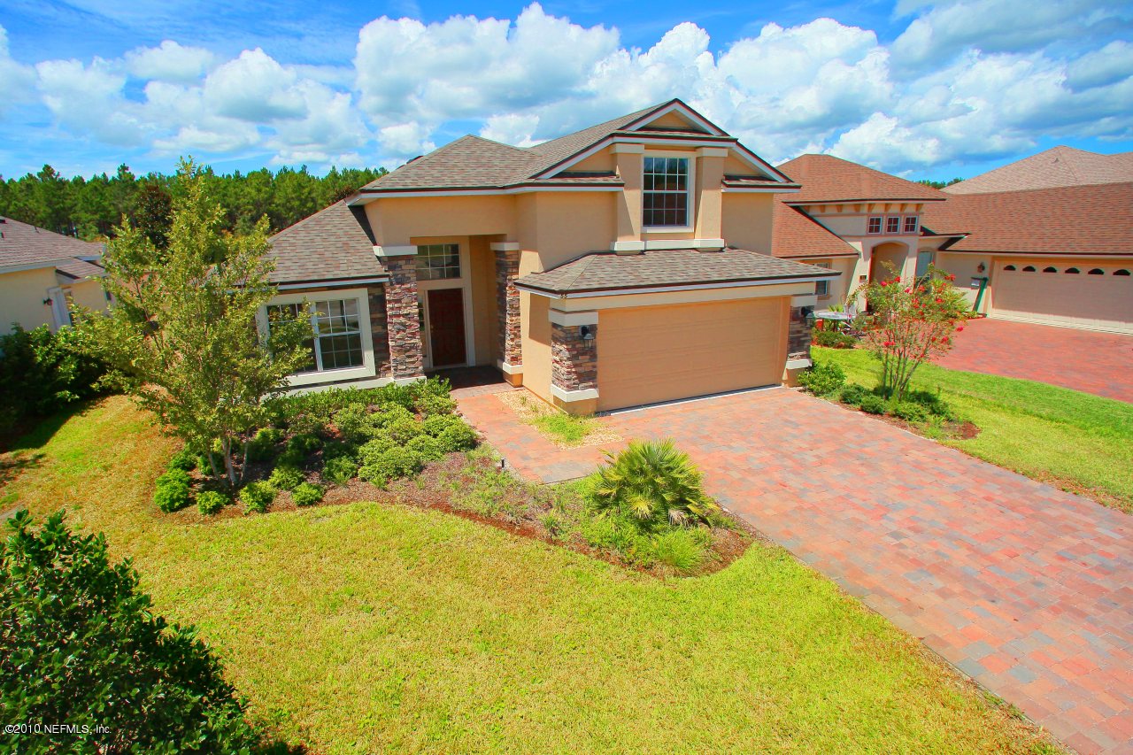 55 Amherst Place Ponte Vedra, FL 32081 - Photo 1 of 17 a front view of a house with a yard and garage