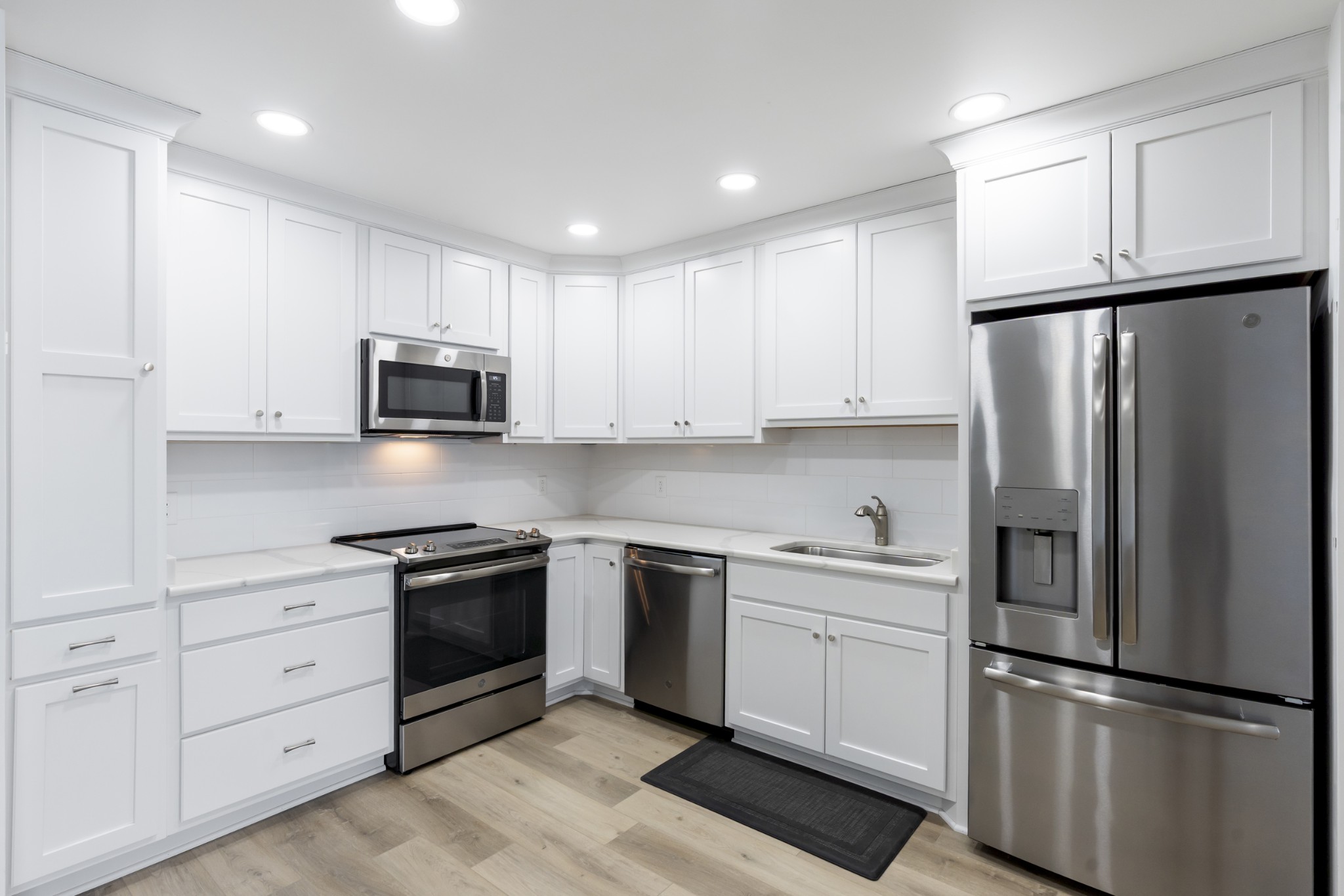 200 Sanders Ferry Road, Unit 2406 Hendersonville, TN 37075 - Photo 3 of 34 a kitchen with white cabinets and stainless steel appliances