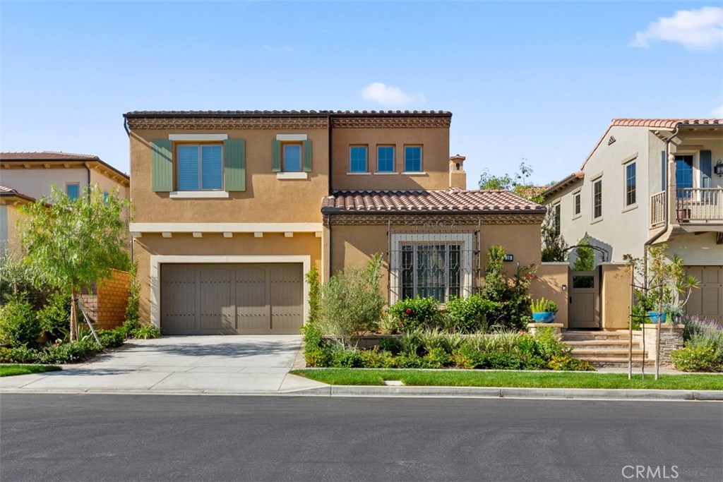 26 Lowland Irvine, CA 92602 - Photo 1 of 44 a front view of a house with a garden and plants