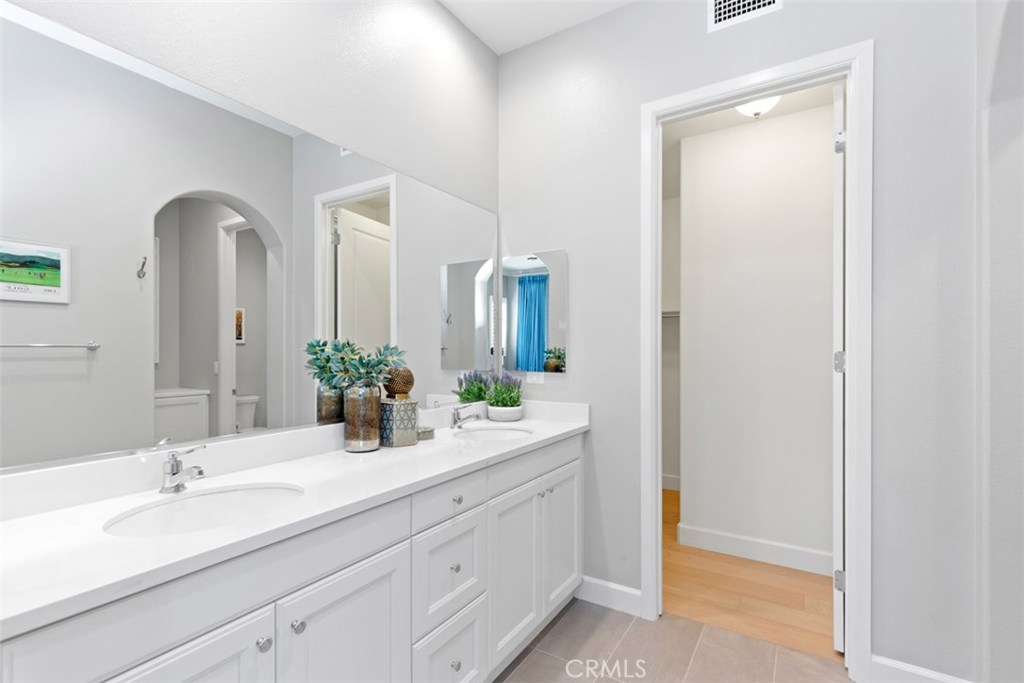 26 Lowland Irvine, CA 92602 - Photo 13 of 44 a bathroom with a double vanity sink and mirror