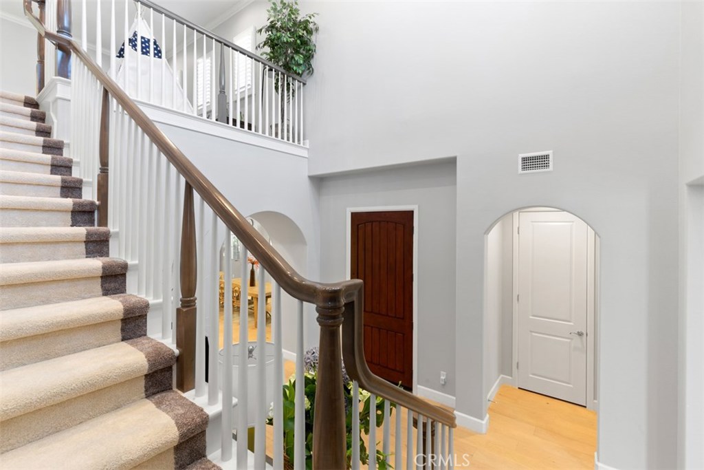 26 Lowland Irvine, CA 92602 - Photo 18 of 44 a view of staircase with lots of frames on wall and a window