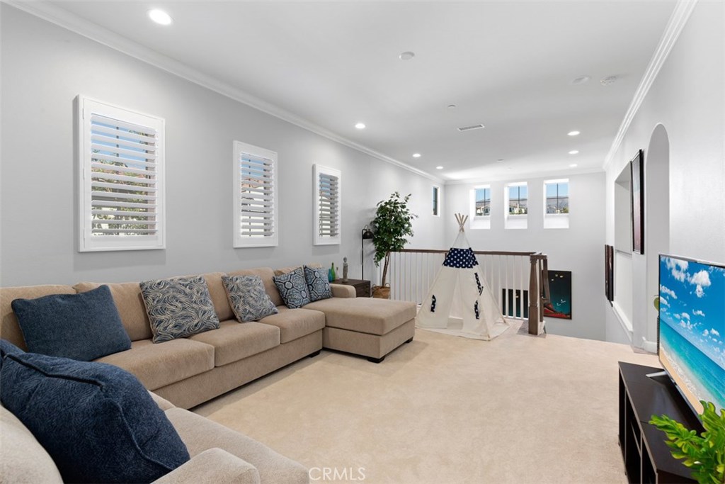 26 Lowland Irvine, CA 92602 - Photo 20 of 44 a living room with furniture and a flat screen tv