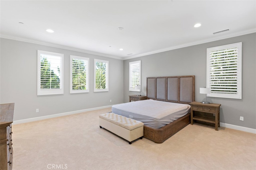26 Lowland Irvine, CA 92602 - Photo 21 of 44 a spacious bedroom with a bed and a window