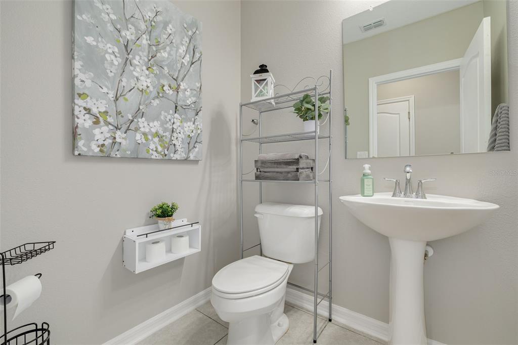 7242 Landmark Drive Spring Hill, FL 34606 - Photo 17 of 45 a bathroom with a toilet sink and mirror