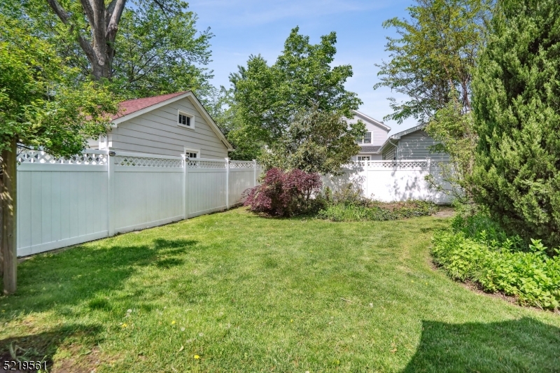 7 Undercliff Road Millburn, NJ 07041 - Photo 14 of 16 a backyard of a house with plants and large tree