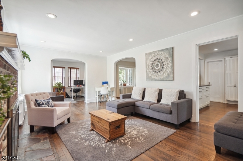 7 Undercliff Road Millburn, NJ 07041 - Photo 2 of 16 a living room with fireplace furniture and a wooden floor