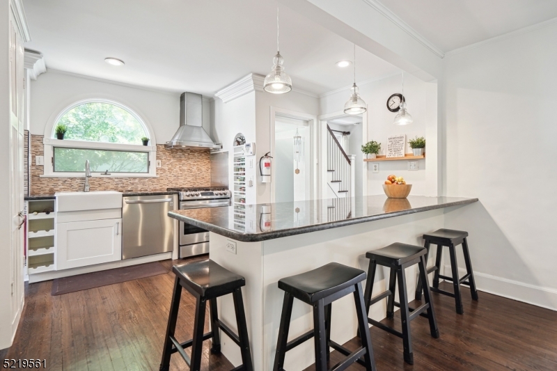 7 Undercliff Road Millburn, NJ 07041 - Photo 4 of 16 a kitchen with stainless steel appliances a table and chairs in it