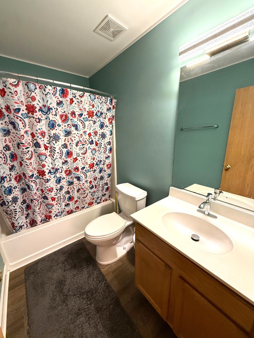 2298 Reflections Drive Aurora, IL 60502 - Photo 22 of 26 a bathroom with a sink a toilet and shower curtain