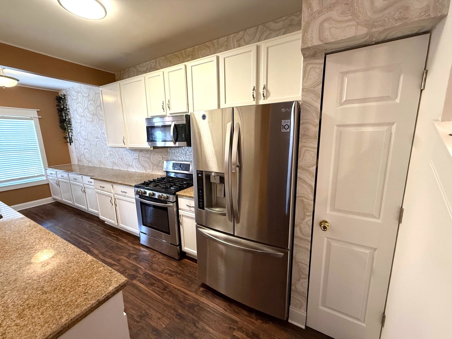 2298 Reflections Drive Aurora, IL 60502 - Photo 4 of 26 a kitchen with stainless steel appliances granite countertop a refrigerator and a sink