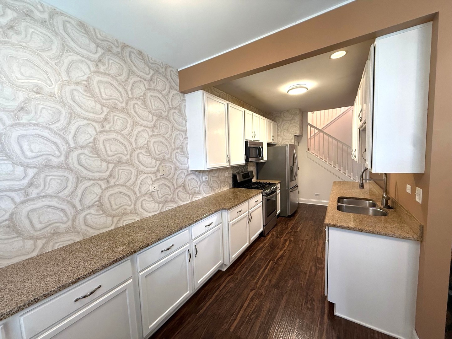 2298 Reflections Drive Aurora, IL 60502 - Photo 6 of 26 a large white kitchen with granite countertop a lot of white cabinets and wooden floor