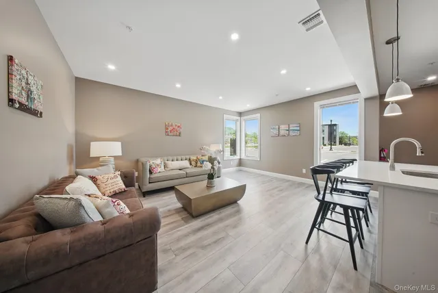 a living room with furniture and view of kitchen