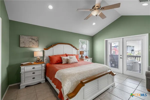 a bedroom with a large bed and a chandelier
