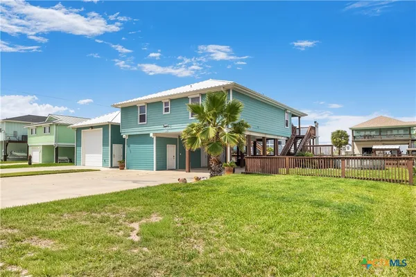 a view of a house with swimming pool and a yard