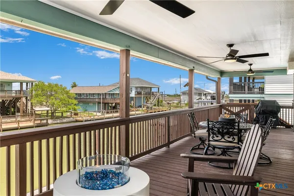 a view of a chairs and table in a balcony