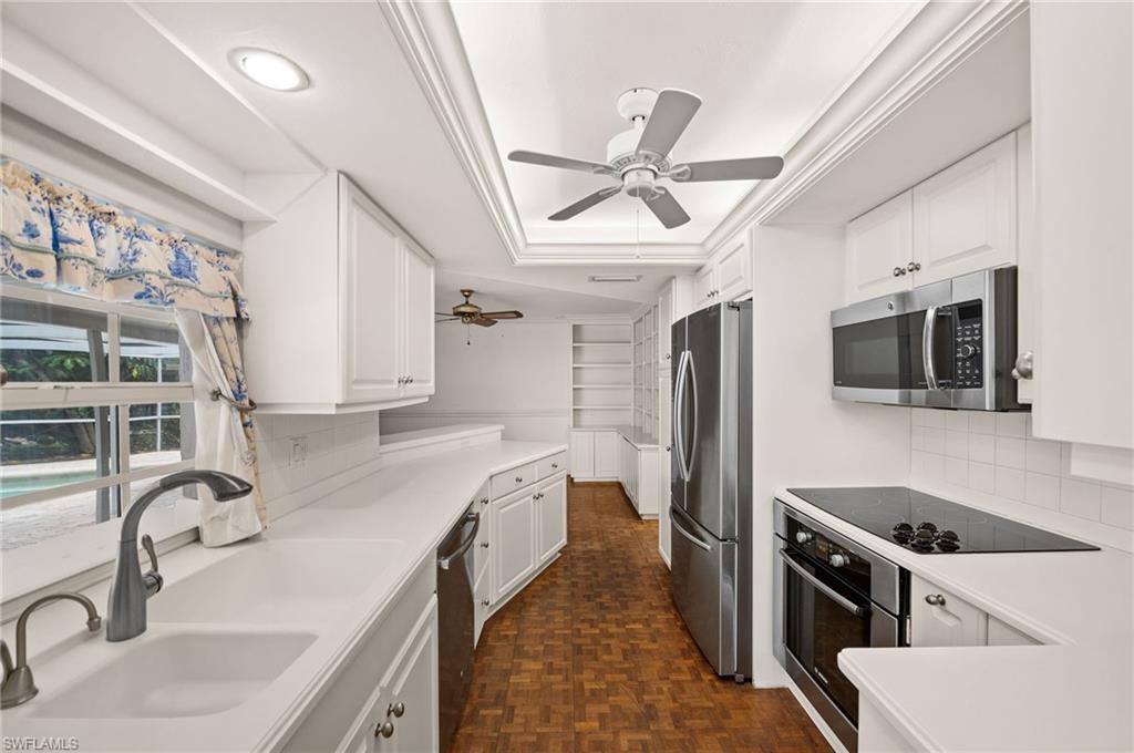 59 Pebble Beach Boulevard Naples, FL 34113 - Photo 11 of 32 a kitchen with stainless steel appliances granite countertop a sink stove and refrigerator