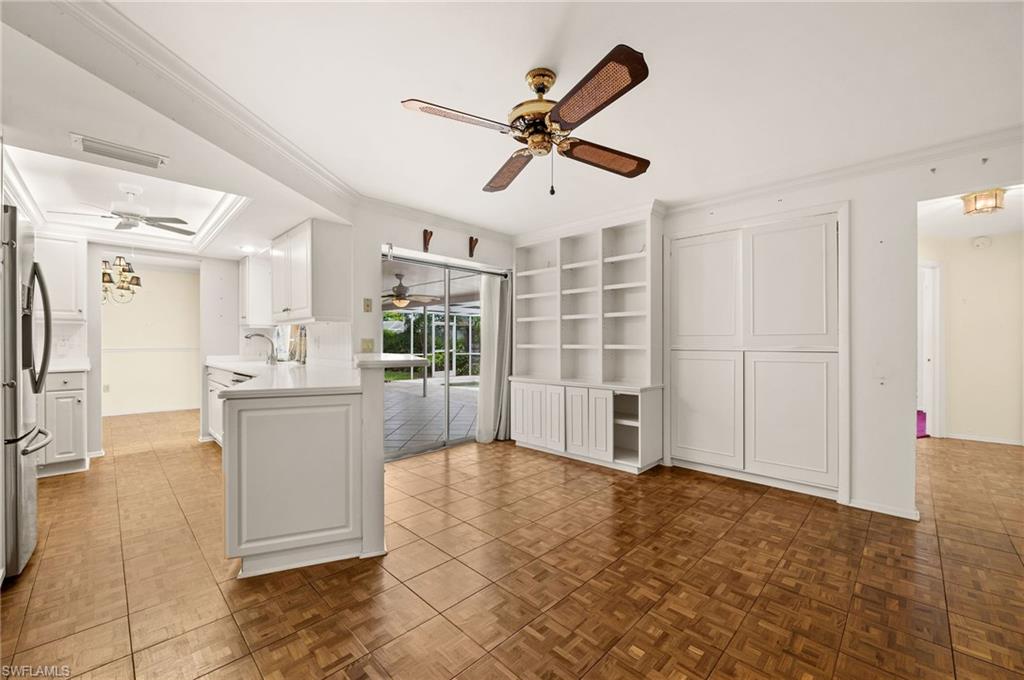 59 Pebble Beach Boulevard Naples, FL 34113 - Photo 12 of 32 a view of livingroom with hardwood floor and a ceiling fan