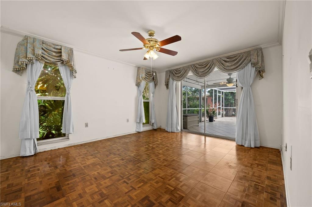 59 Pebble Beach Boulevard Naples, FL 34113 - Photo 14 of 32 a view of a livingroom with a ceiling fan and window
