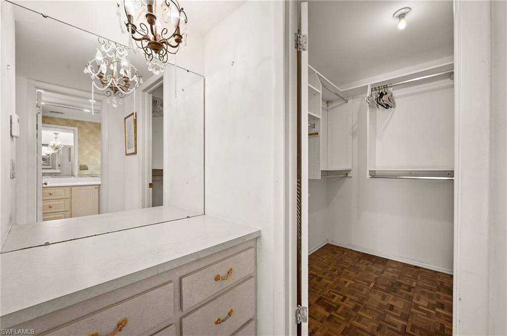 59 Pebble Beach Boulevard Naples, FL 34113 - Photo 18 of 32 a bathroom with a mirror sink and vanity