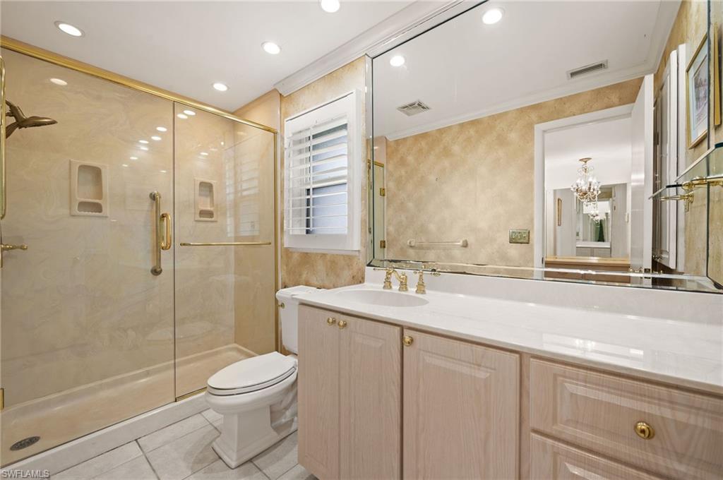 59 Pebble Beach Boulevard Naples, FL 34113 - Photo 19 of 32 a bathroom with a sink a toilet and shower