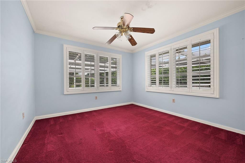 59 Pebble Beach Boulevard Naples, FL 34113 - Photo 20 of 32 an empty room with windows and ceiling fan