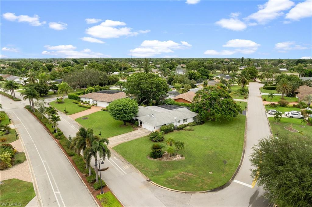 59 Pebble Beach Boulevard Naples, FL 34113 - Photo 2 of 32 a view of a lake with a yard
