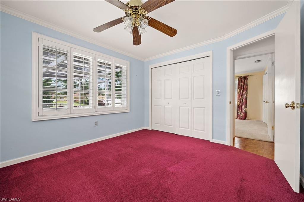 59 Pebble Beach Boulevard Naples, FL 34113 - Photo 21 of 32 a view of a room with a ceiling fan and a window