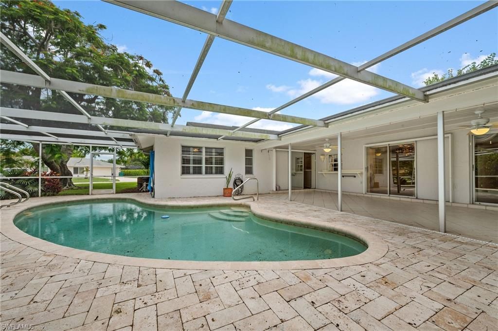 59 Pebble Beach Boulevard Naples, FL 34113 - Photo 23 of 32 a view of a house with a swimming pool