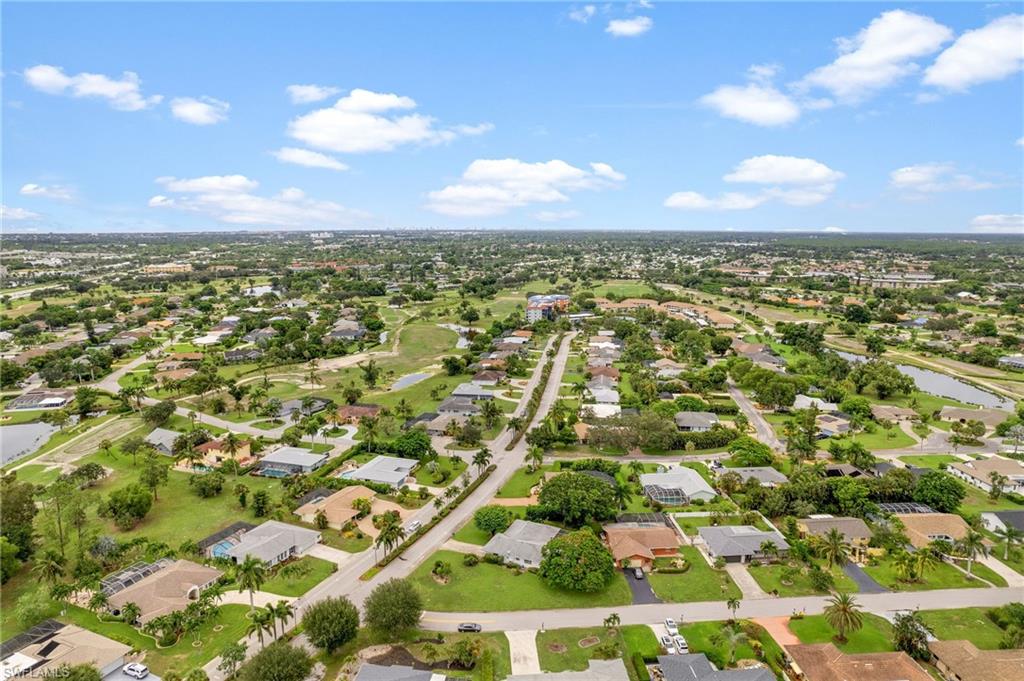59 Pebble Beach Boulevard Naples, FL 34113 - Photo 32 of 32 an aerial view of residential building with green space