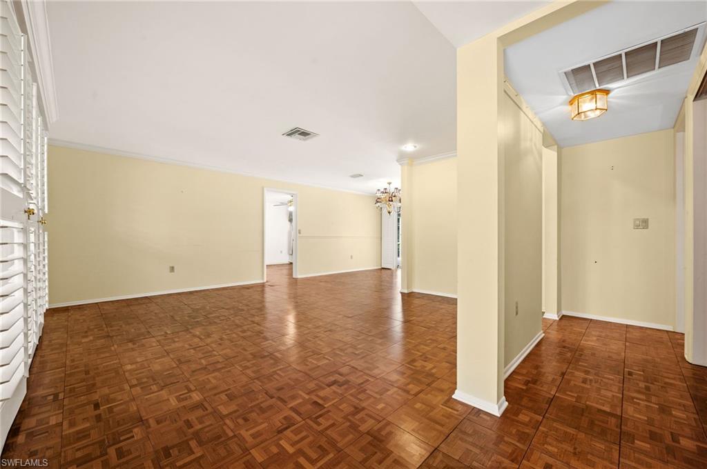 59 Pebble Beach Boulevard Naples, FL 34113 - Photo 4 of 32 a view of a hallway with wooden floor