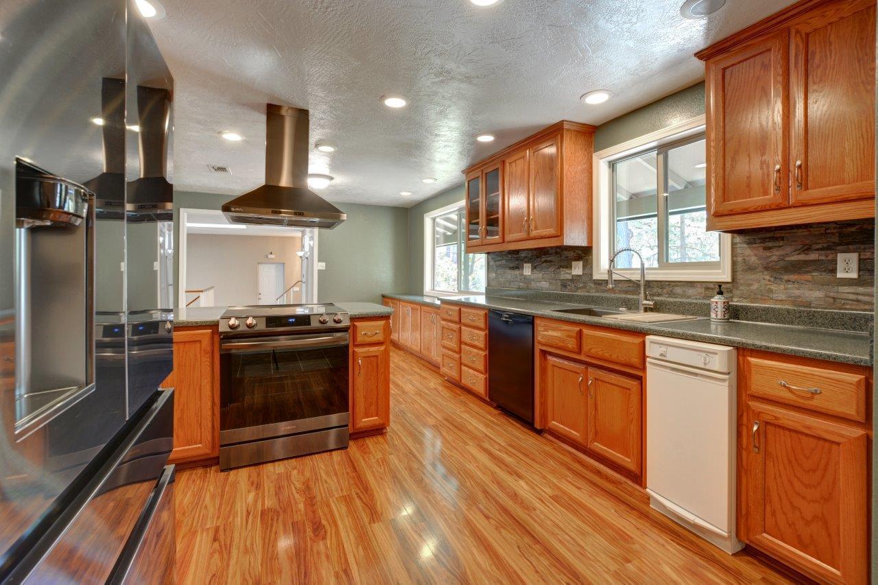833 Upper Applegate Road Jacksonville, OR 97530 - Photo 15 of 58 a kitchen with stainless steel appliances wooden cabinets stove and a sink