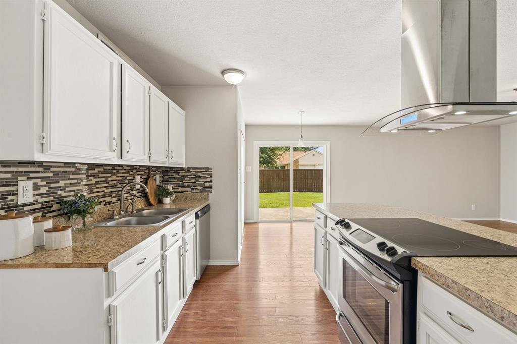5620 Perrin Street The Colony, TX 75056 - Photo 9 of 31 a kitchen with stainless steel appliances granite countertop a sink and a stove