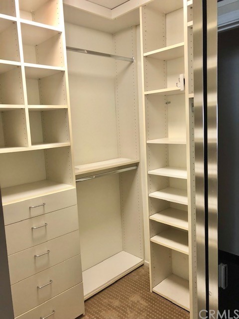 5 Torrigiani Aisle Irvine, CA 92606 - Photo 21 of 28 a view of walk in closet with empty racks
