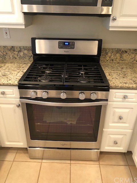 5 Torrigiani Aisle Irvine, CA 92606 - Photo 7 of 28 a stove top oven sitting inside of a kitchen