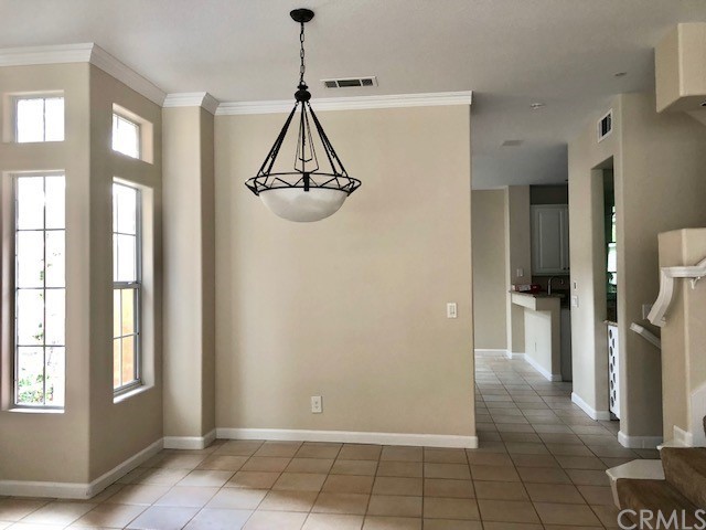 5 Torrigiani Aisle Irvine, CA 92606 - Photo 9 of 28 a view of a room with a window and chandelier