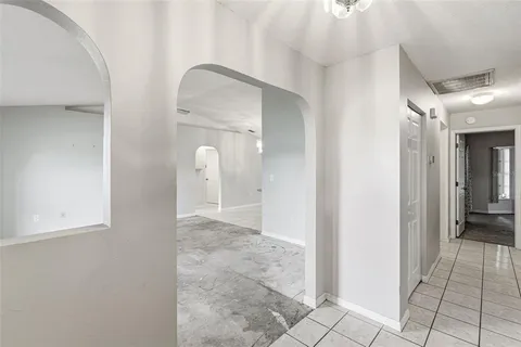 a view of a bathroom with mirror and shower
