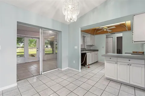 a kitchen with white cabinets and appliances