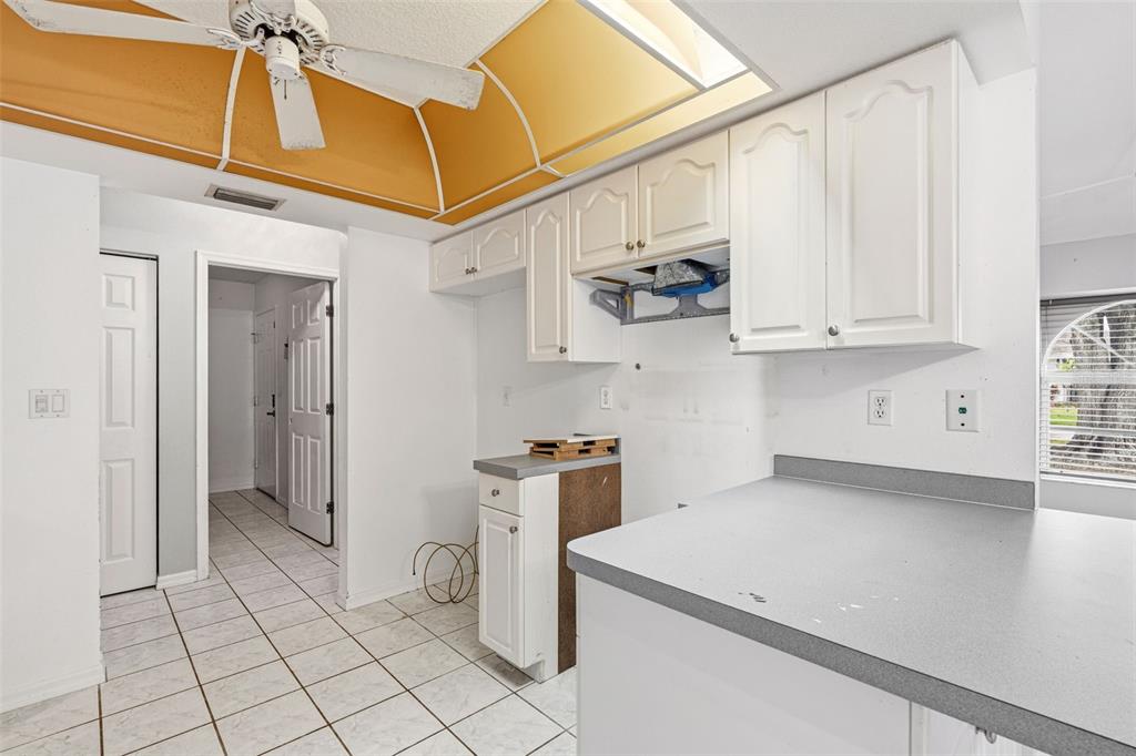 7510 Ligustrum Punta Gorda, FL 33955 - Photo 7 of 25 a kitchen with stainless steel appliances white cabinets and a window