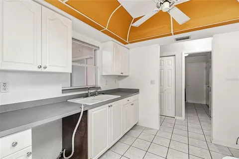 a kitchen with a sink cabinets and utility