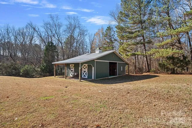 a front view of a house with a yard covered in snow