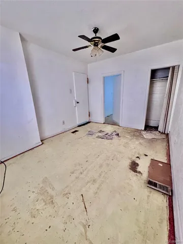 a view of a livingroom with a ceiling fan and wooden floor