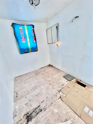 a bedroom with a bed and painting on the wall