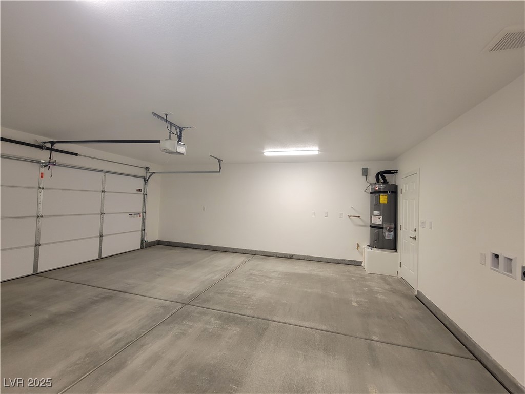 1021 East Manse Road Pahrump, NV 89048 - Photo 21 of 25 Garage with water heater and a garage door opener