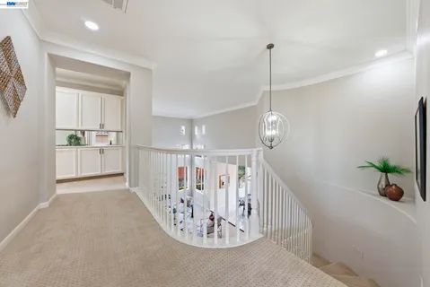 a view of a hallway with chandelier