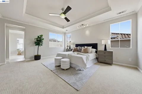 a bedroom with bed and a chandelier