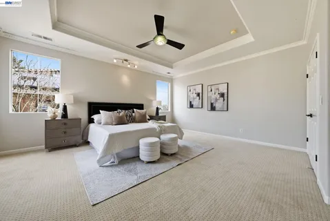 a bedroom with a white bed and white walls