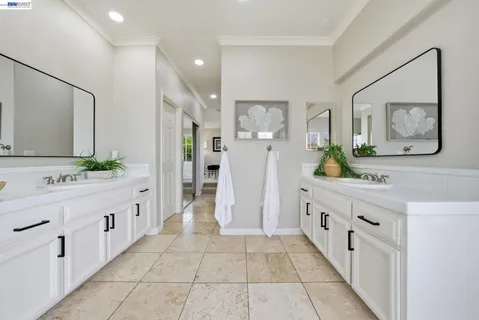 a bathroom with a double vanity sink and a mirror