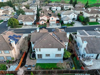 an aerial view of multiple houses with a yard