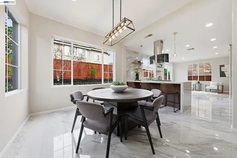 a view of a dining room with furniture and a large window