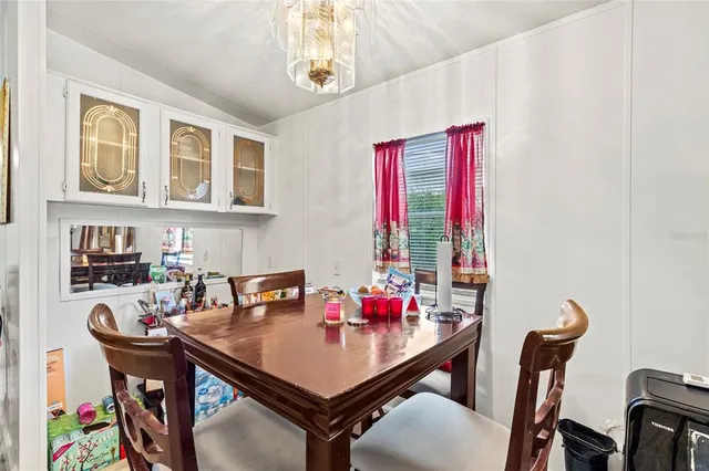 a view of a dining room with furniture and a window
